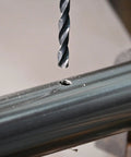 1/4 Inch By 8 Inch Long Drill Bit With Black Oxide Coating And Cobalt Alloy, shown drilling into a metal surface