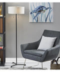 Wesley 60-Inch Floor Lamp Black Modern Tall Floor Lamp With Dual 60W Sockets next to gray chair and turtle painting