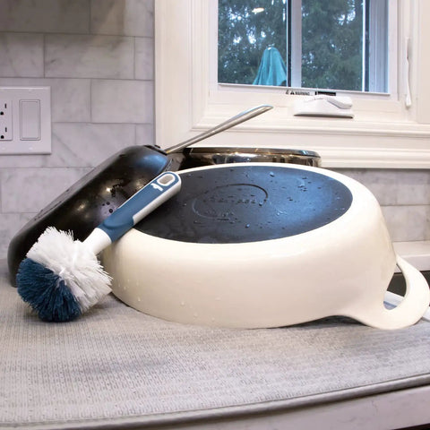 Heavy Duty Sink And Dish Scrub Brush With Safe Bristles, Perfect For Pots And Pans, next to dirty cookware.