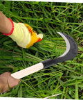 Person using Durable Manganese Steel Scythe Long Hand Hoe For Garden Weeding Heavy Duty Yard Work Hand Weeder Tool in grass