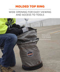 User using 5973 Large Nylon Hoist Bucket Tool Bag With D-Rings And Zipper Top Gray, Workhorse Build With 1200D Body