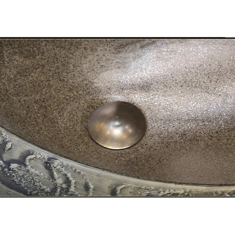 Close-up of USZWBY Bathroom Sink Creativity Ceramic Vessel Sink with stone texture and metal drain in the center.