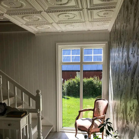 Laurel Wreath Faux Tin Ceiling Tile 2x2 PVC Antique Copper Finish in a bright room, highlighting intricate design and DIY transformation.