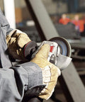 Worker using heavy duty 5 inch angle grinder with 13.5 amp motor and 11000 RPM electronic speed stabilization Non Locking Paddle Switch
