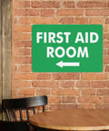 Left Arrow First Aid Room Outdoor Medical Safety Sign 8x12 Aluminum Wall Decor on brick wall.