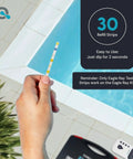 Hand holding a strip from Digital Pool Water Tester Kit With 30 Strips And Digital Reader For Total Chlorine Free Chlorine Bromine Total Hardness Cyanuric Acid Alkalinity And pH No Guesswork Easy Readouts by a pool