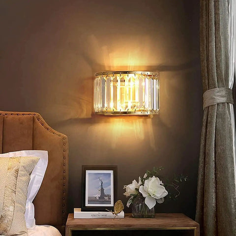BUNCC Modern Minimalist Metal Wall Sconce, E14 LED Crystal Indoor Wall Light Fixture mounted beside a bed in a cozy decor setting.