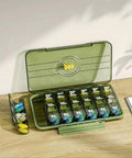 Green portable medicine organizer with individual compartments for pills, displayed open on a wooden table.