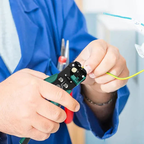 Hands using Heavy Duty Automatic Wire Stripper And Adjustable Crimping Tool For Precise Electrical Wiring on green wire.