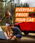 Couple setting up a tent in the woods near a red car with text 'Everyday Proof Your Car'