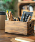 Wooden pencil holder with various office supplies on a desk.