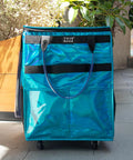 Front view of Glitter Blue Rolling Grocery Tote With Wheels And Zipper Covered 8 Pocket Organizer Foldable Durable Tote.