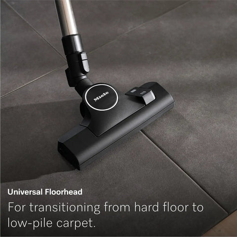 Premium Bagged Canister Vacuum For Hard Floors And Thin Carpet Featuring XL Parquet Brush Universal Floorhead Footswitch Hygienic Air Filter For Badass Suction And Slick Cleanup on tiled surface.