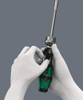 Ratcheting 7 Pc Screwdriver Set With 1 Quarter Inch Drive, Fine Tooth Ratchet, shown held in hands demonstrating switchover ring use.