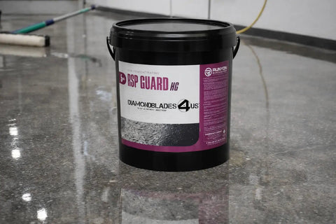 Hardcore 5 Gallon High Gloss Concrete And Floor Sealer That Kicks It With Slick Stain Resistance And Lithium Fortified, black bucket on polished floor.