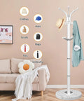 Sleek Freestanding Coat Rack With 360 Degree Swivel Hooks And Marble Base in a living room setting with clothes displayed.