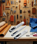 Three-Piece Grommet Hole Punch Set for Leatherworking with 1/4, 3/8, 1/2 inch steel punches on workbench with leather and tools