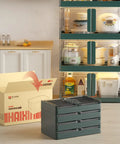 Kickass 19 Gallon Heavy Duty Foldable Storage Bin With Snap On Front Opening And Secure Lid Stackable Plastic Organizer Box Dope Green stacked in modern kitchen.