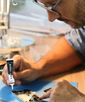 Technician applying Ultra Strong T7000 Phone Repair Glue For Screen And Frame Repair Multipurpose Adhesive to cell phone components.