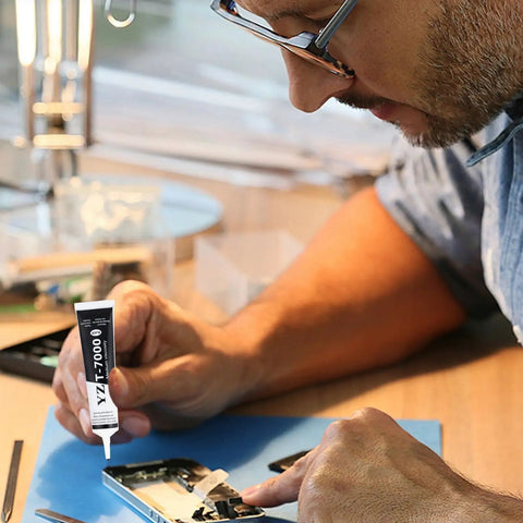 Technician applying Ultra Strong T7000 Phone Repair Glue For Screen And Frame Repair Multipurpose Adhesive to cell phone components.