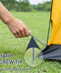 Using Heavy Duty Screw In Tent Stakes Eight Inch Ground Anchors Metal Stakes For Camping Includes Hex Head Driver And Sturdy Storage Bag 20 Pack Bright Orange Finish to secure a tent on grass.