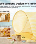 Pop Up Baby Beach Tent With 2026 Upgraded UV Protection showing sandbag pockets and ground stakes on sandy beach