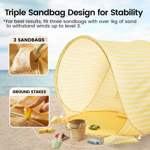 Pop Up Baby Beach Tent With 2026 Upgraded UV Protection showing sandbag pockets and ground stakes on sandy beach