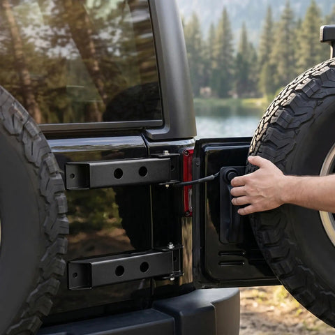 Heavy Duty Tailgate Hinge Set For Jeep Wrangler JK and JKU 2007 through 2018 shown on a black Jeep during tire maintenance.