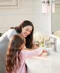 Woman and child using Chrome Bathroom Faucet for 1 Hole Sink, Stainless Steel Lavatory Faucet with Metal Pop Up Drain in modern bathroom