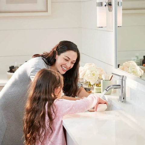 Woman and child using Chrome Bathroom Faucet for 1 Hole Sink, Stainless Steel Lavatory Faucet with Metal Pop Up Drain in modern bathroom