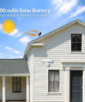 White house with Solar Powered Motion Sensor Outdoor Light With 1600 Lumen White Flood Beams mounted near black door