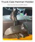 Close-up of black hard hat headrest hook organizer mounted on truck cab seat back for holding helmet securely in place.