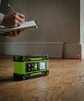 4 In 1 Digital Laser Tape Measure With Dual HD Display, 200 Ft Rechargeable Laser Distance Meter, 33 Ft Green Cross Line Laser, 10 Ft Tape, Handy For Quick Area, Volume, Pythagorean, And Leveling On Indoor Projects. Green laser meter on floor with red beam during room measurement