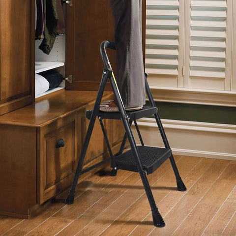 Heavy Duty 2 Step Folding Ladder With 500 Lb Capacity Anti Slip Wide Pedals Beefy Steel Frame used in home for reaching cabinet