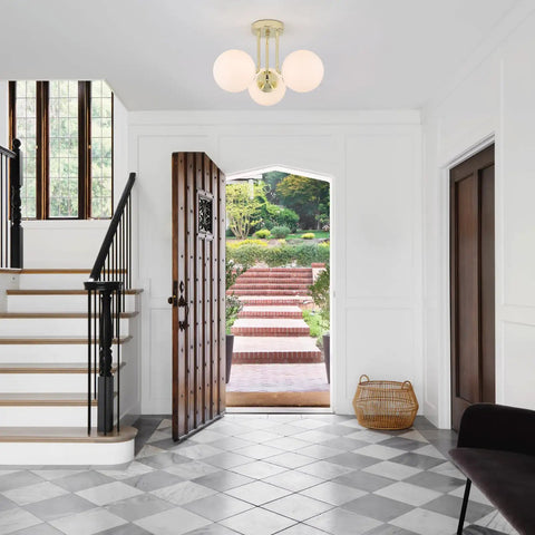 Gold 3 Light Semi Flush Mount Ceiling Light Fixture With Off White Hand Blown Glass Shade illuminating a modern hallway.