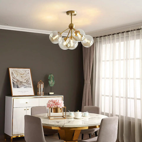 5 Light Amber Glass Globe Chandelier With Brass Gold Finish, Semi Flush Mount in dining room setting, mid-century modern style