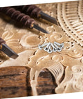 Close-up of 100 Pcs Iron Brads For Paper Crafting And Puppet Making Kit on an intricately carved wooden background.