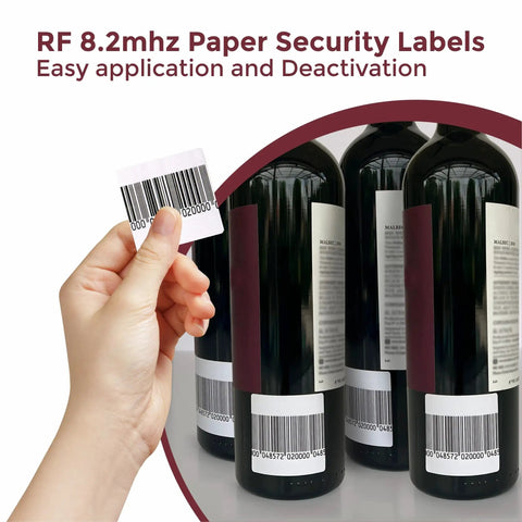 Hand applying 1000 White Paper Security Labels 1.5 X 1.5 Inch RF 8.2MHz Tech Fake Barcode Checkpoint Compatible on wine bottles.