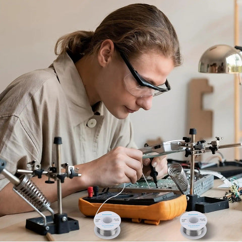 Person soldering a circuit with 63-37 Tin Lead Rosin Core Solder Wire For Electrical Soldering 0.6mm Diameter 50g Reel Pro Grade Low Melting Point 183 C