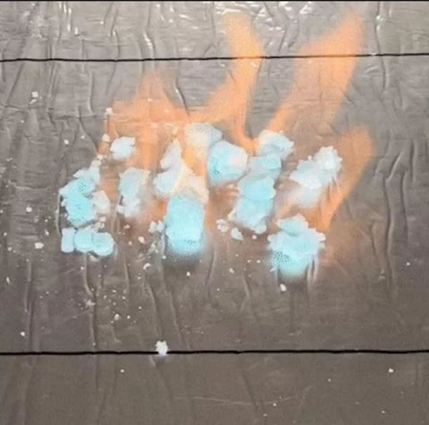 Flame igniting on blue-white material, showcasing Heavy Duty Waterproof Roofing Tape Roll For Asphalt Shingle Repair.