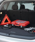 Red and black Grab-And-Go Portable Plastic Tool Box With Handle For Hardware Storage, in a car trunk, compact 11.8 x 10.2 x 3.9 inches.