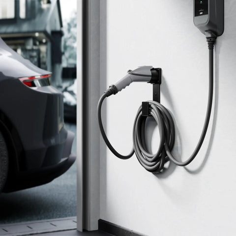 Heavy Duty Stainless Steel EV Charger Holder For J1772 Connectors Wall Mount Cable Organizer installed next to a car.