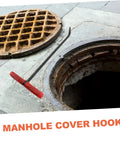 Heavy Duty Manhole Cover Lifter Hook Rock Solid Steel Build With Secure Comfort Handle And Slick T Shape Design For Quick Grate Drain Lid And Roller Shutter Access Without Any Fuss At All, showing a red handled hook next to a manhole.