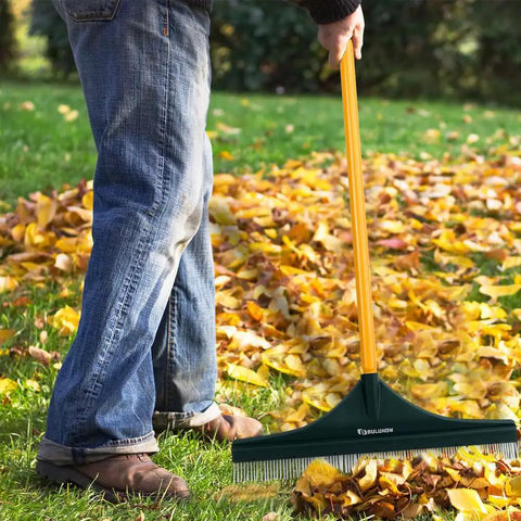 Man using 55 Inch Turf Rake With Dense Nylon Bristles All In One Long Pole Garden Hand Broom for leaf cleanup on lawn
