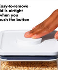 Hand pressing button on Keep It Fresh With Airtight Pop Containers, 4.4 Qt Capacity, Stackable Dry Food Storage That Fits Your Pantry