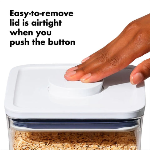 Hand pressing button on Keep It Fresh With Airtight Pop Containers, 4.4 Qt Capacity, Stackable Dry Food Storage That Fits Your Pantry