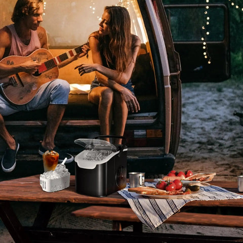 Portable On The Go Ice Maker That Churns 8 Ice Cubes In 6 Minutes at a campsite with a couple playing guitar