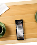 Six Piece White Sketch Pencils Set For Charcoal Drawing Artists And Newbies Soft Medium Hard Graphite displayed on a table