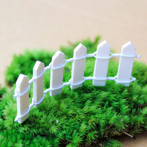 Four Piece 35 Inch White Wood Picket Fairy Garden Fence Set for Dollhouse Miniatures and Home Garden Displays on moss