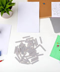 50 White Cylinder Eraser Refills 5x25mm For Mechanical Pencils Top Notch Premium Rubber Erasers scattered on a desk